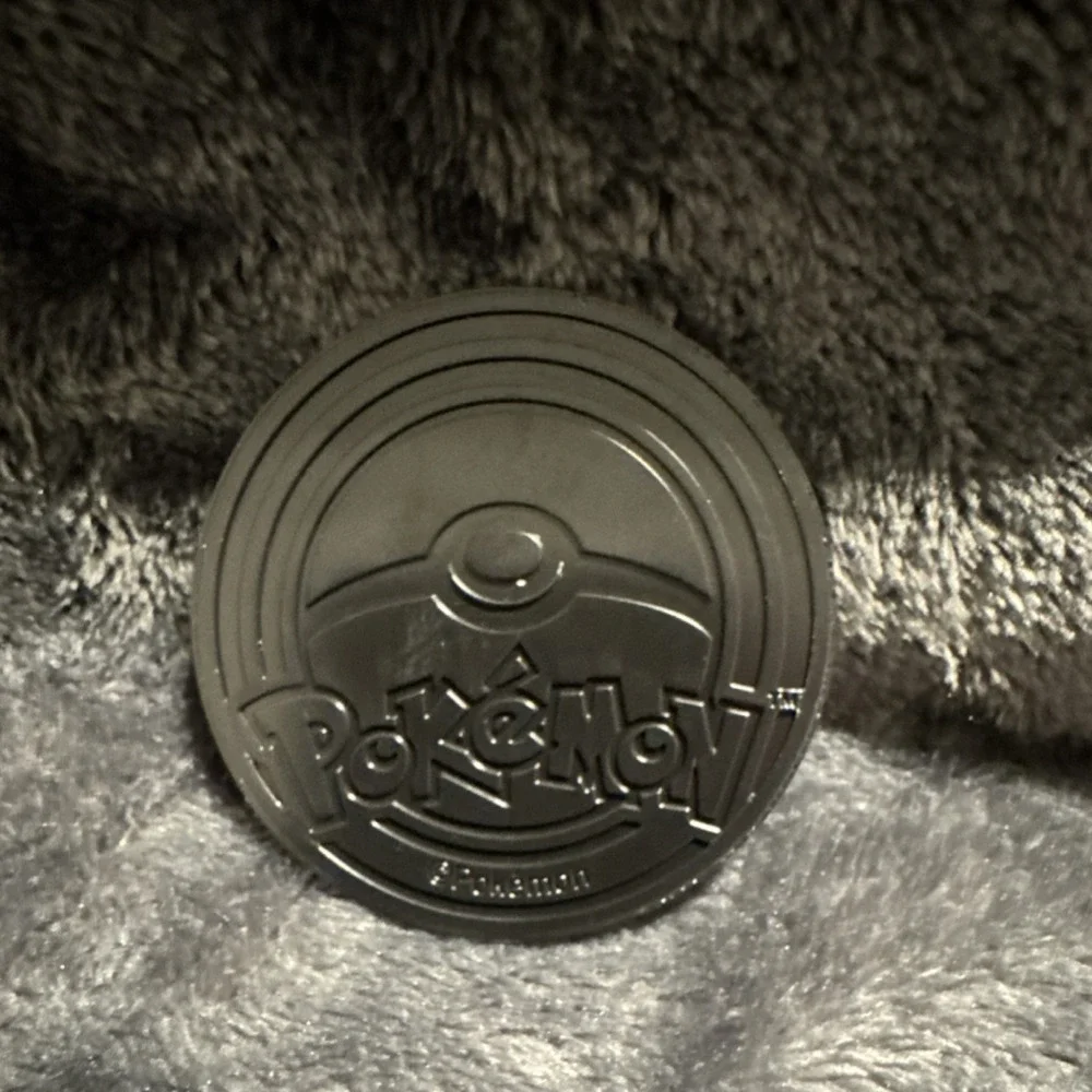 Nintendo Pokémon TCG Grookey Embossed Metal Flip Coin 1.2in Black/Gold/Copper